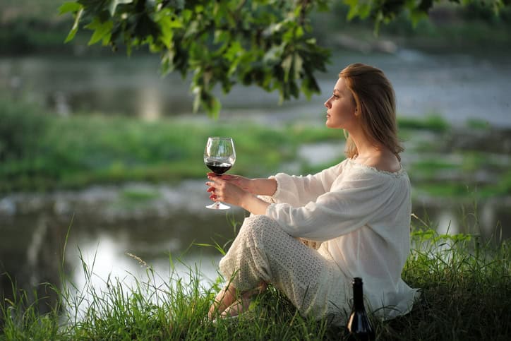 Alluring lady in sunset near river