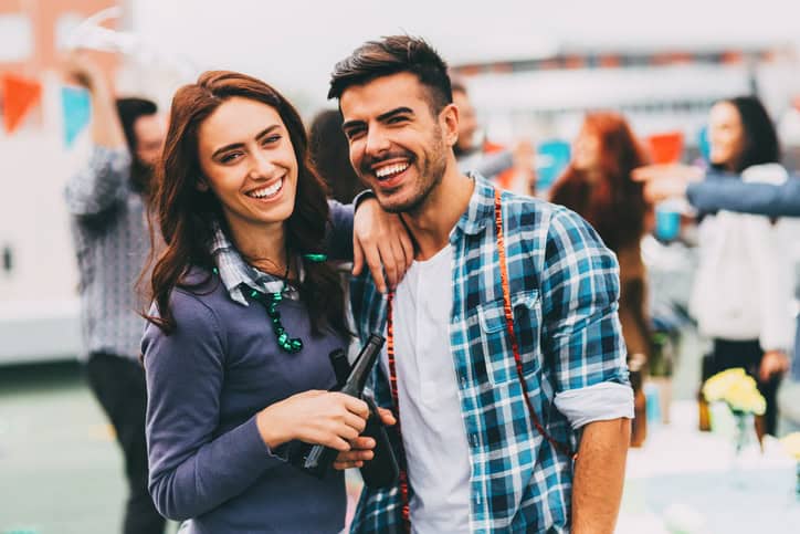 Couple laughing drinking