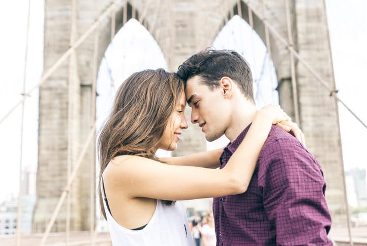 Young couple kissing on the Brooklyn bridge. Concept about travel and relationship