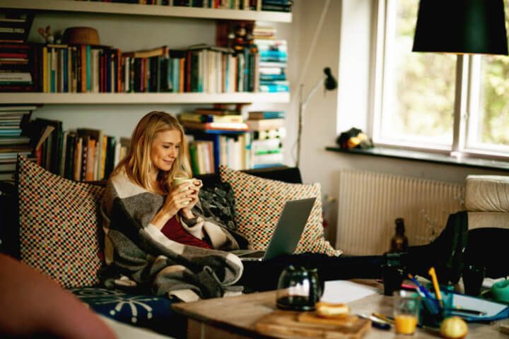 Photo of a young woman enjoying coffee and movie