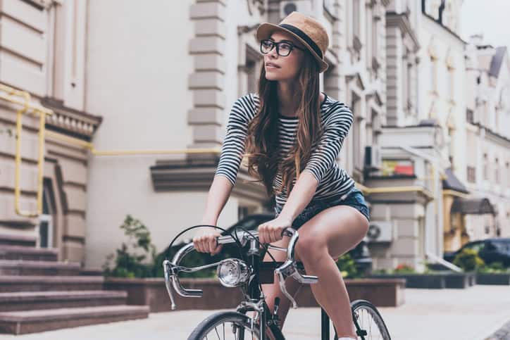 beautiful woman riding bicycle in city