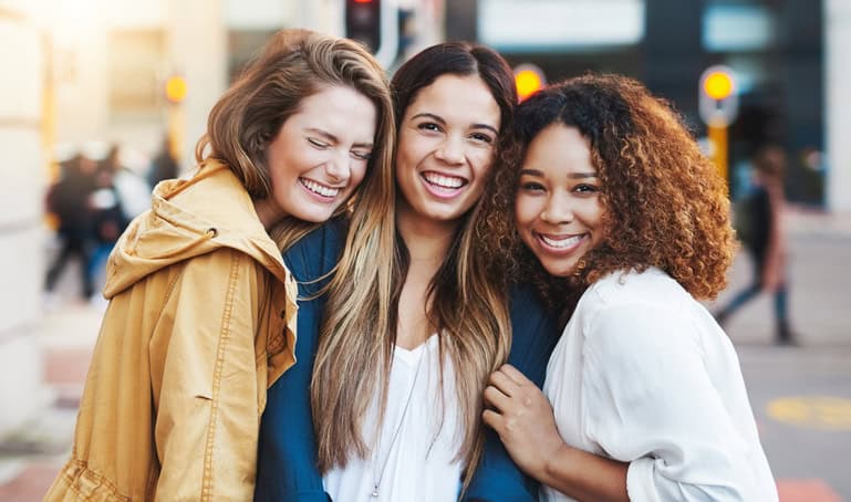 Cropped shot of three friends having fun in the city