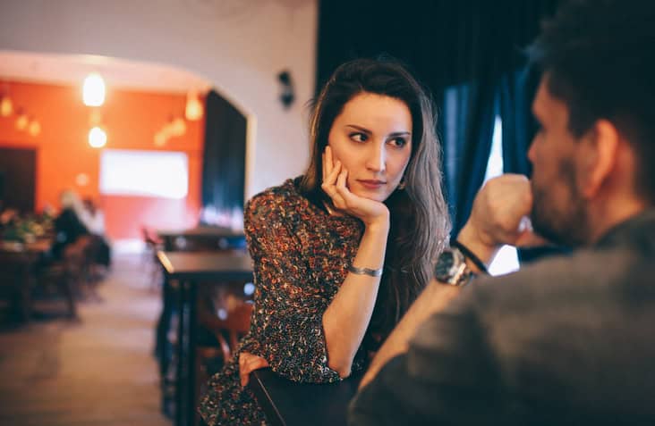 woman looking at man across a table