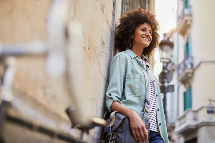 Young hipster woman in the streets of Barcelona commuting. Mixed race model, spanish and Ethiopian.