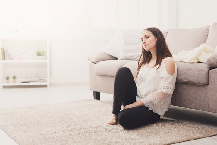 Beautiful girl thinking on the floor