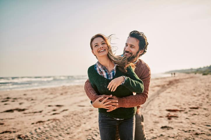couple outside embracing on a beach