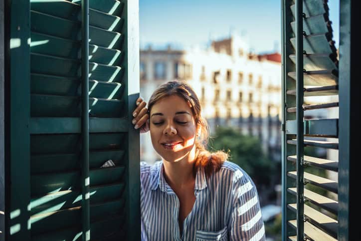 woman relaxing near a window in the sun