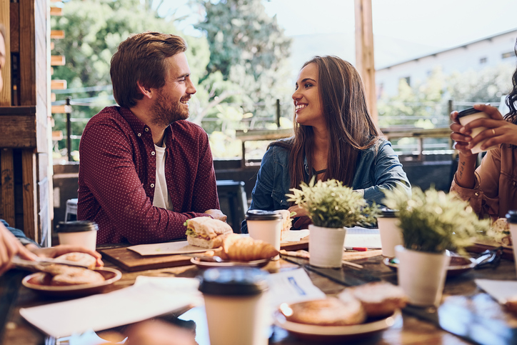 Cropped shot of a happy young couple out for lunch at a cafe