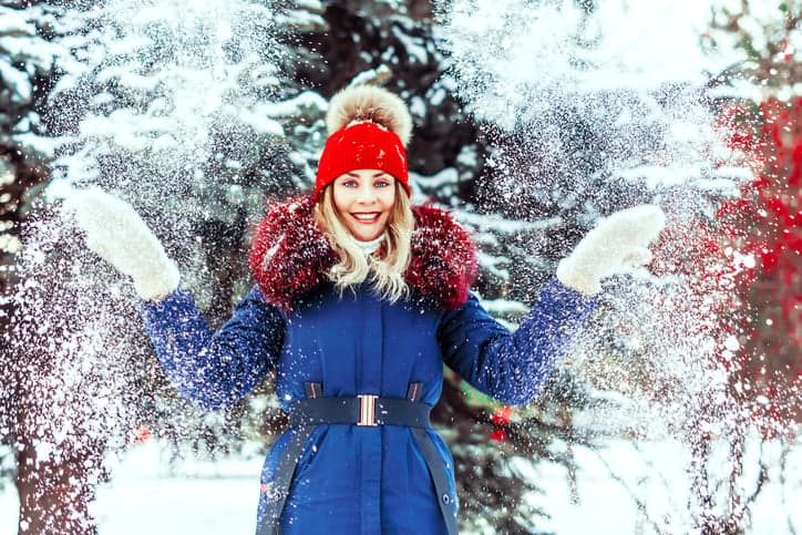 smiling woman christmas in snow