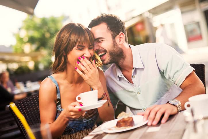 Young couple having fun on a date in cafe.