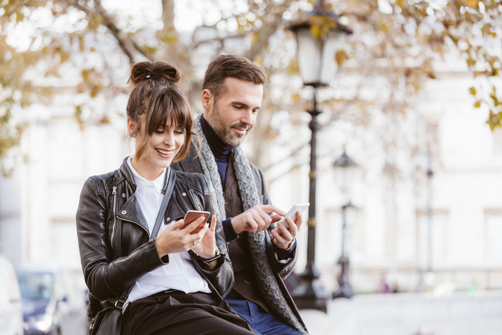 Couple sitting outdoors in city