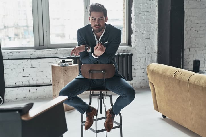 Charming man sitting on a chair