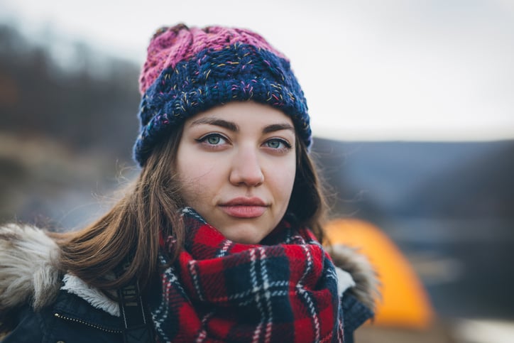 Young camper woman in a front of the tent