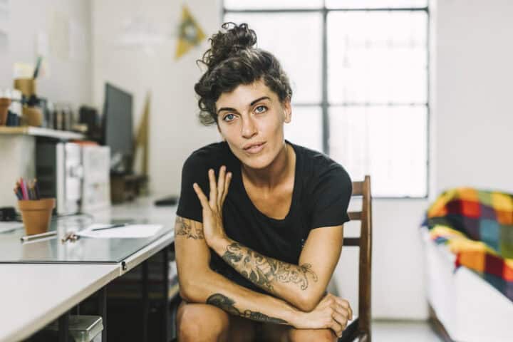 tatooed woman in art studio