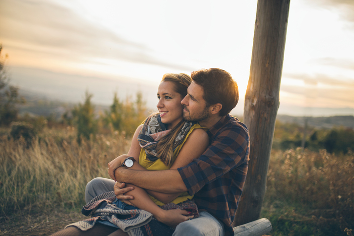 Couple enjoying a sunny day in late summer outdoors in nature
