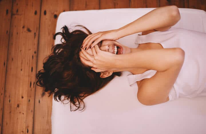 Woman covering her face in embarrassment.