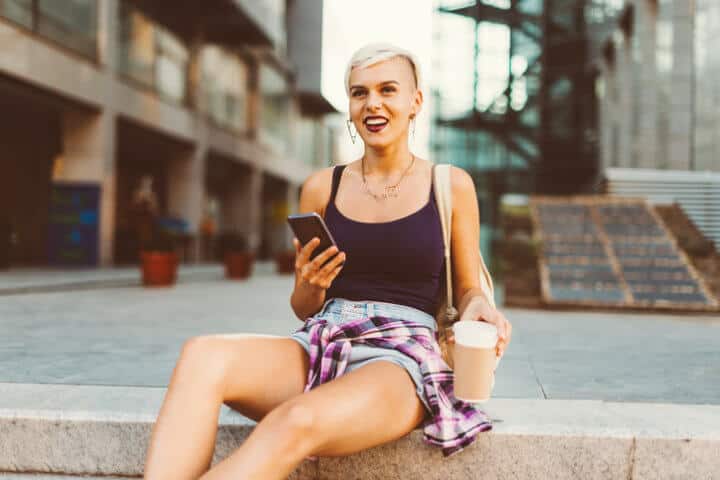 Casual woman having a coffee break on the street