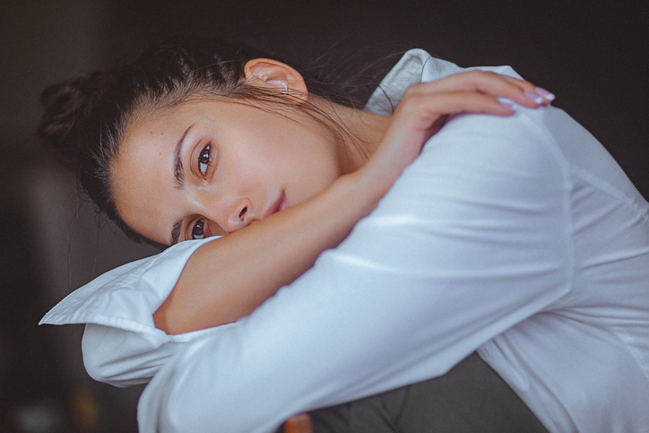 fresh faced woman leaning down