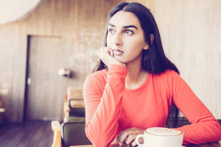 woman in orange depressed
