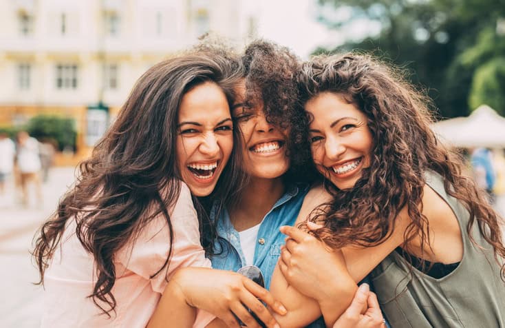 three women friends hugging
