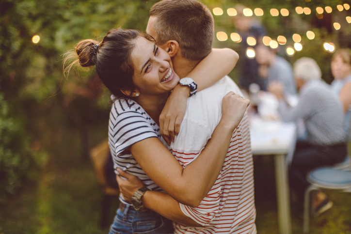 Young couple hugging.