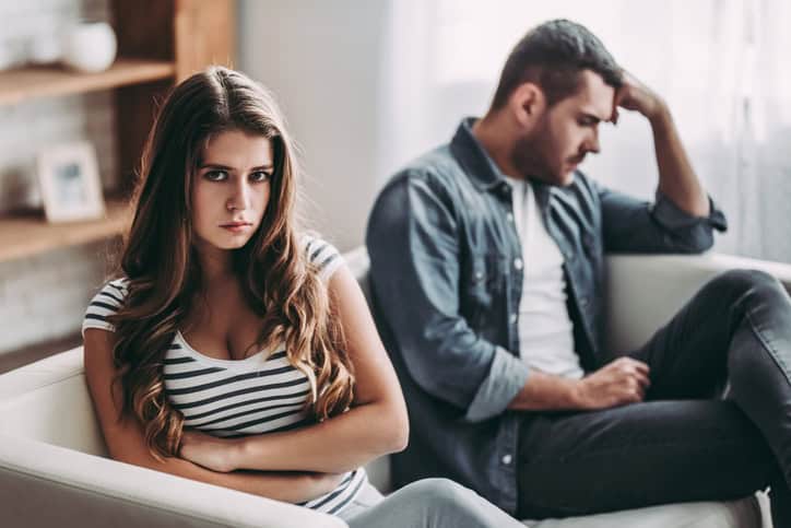 Upset couple at home.