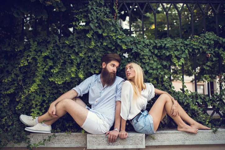 Young loving couple looking at each other outdoors.