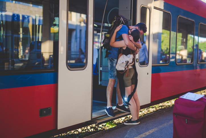Couple hugging goodbye at the train station.