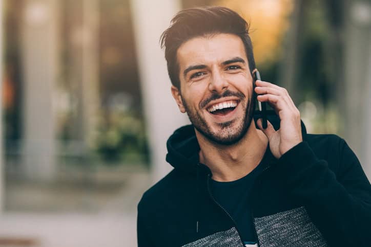 Young man using a smart phone outdoors.
