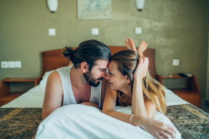 couple in bed about to kiss