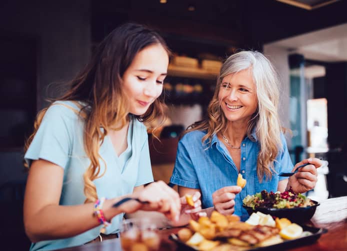 mother and daughter eating lunch