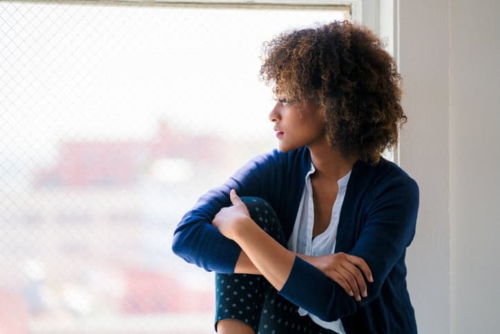 african americn woman looking out the window