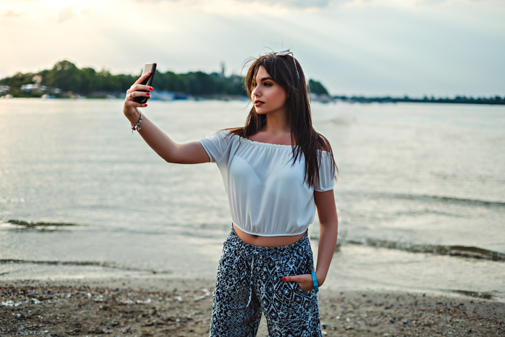 woman taking a selfie near the beach