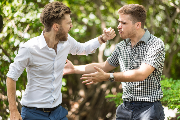 Two men in a violent fight.
