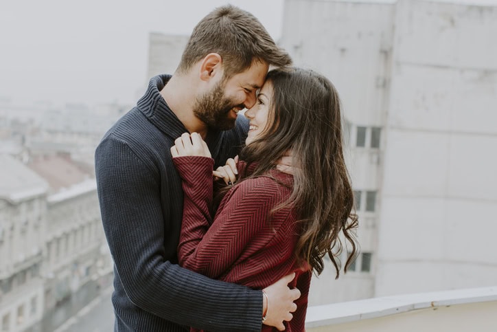 couple embracing outsid