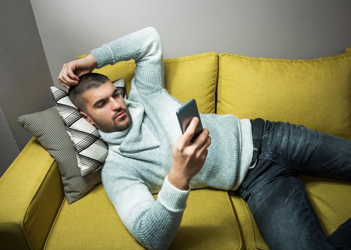 Young man surfing the internt from phone