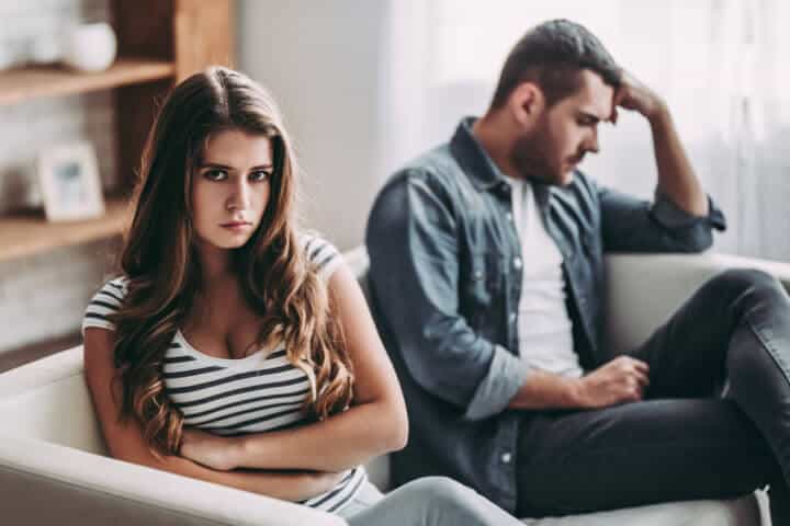 Upset couple at home.