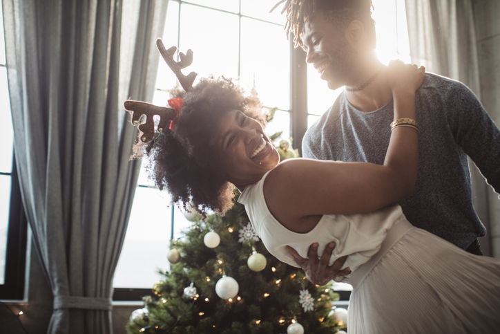 Couple dancing at the Christmas tree.