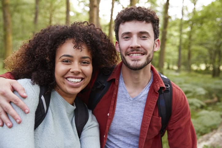 bi-racial couple smiling in the park