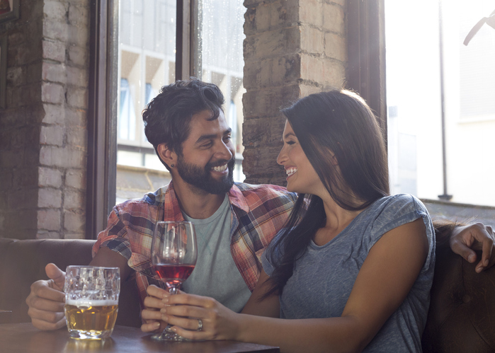 Happy couple sitting in bar on a date.