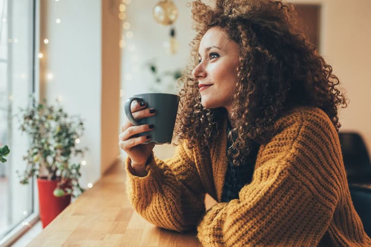 Attractive woman drinking coffee at the cafe.
