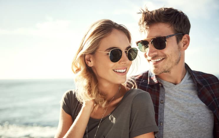 couple wearing sunglasses at the beach
