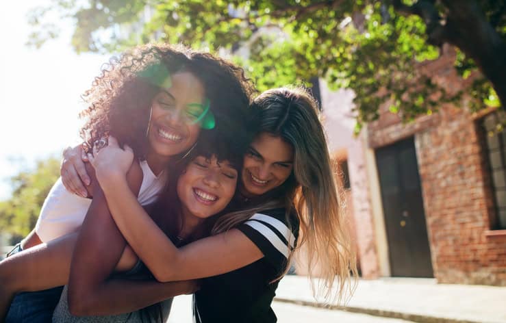 Group of female friends enjoying outdoors on city street