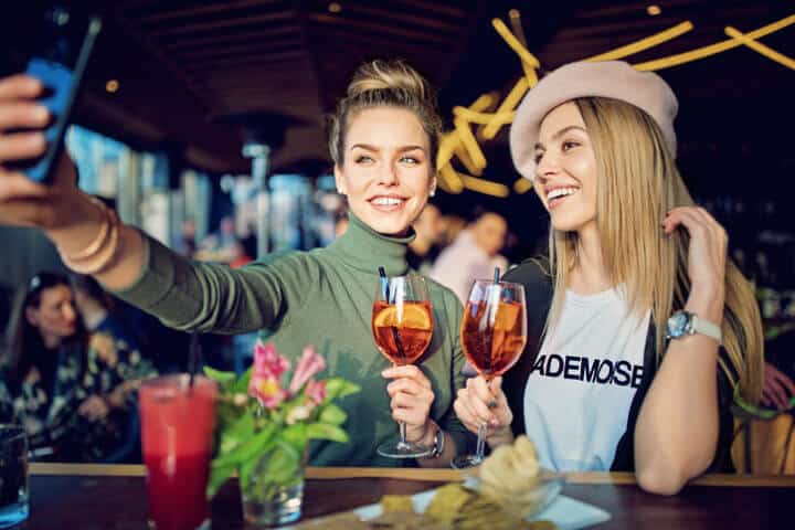 Women drinking at a bar.