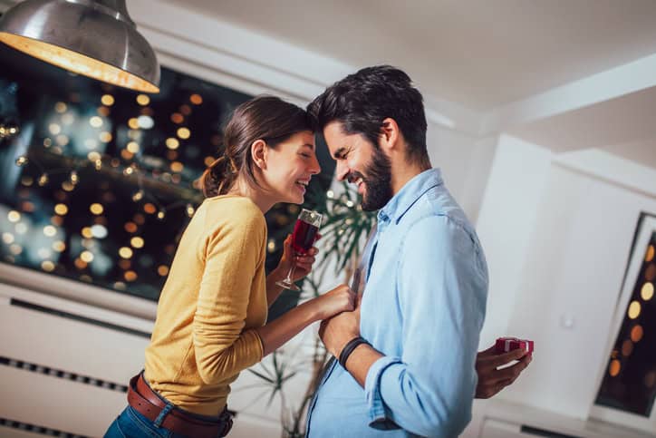 Young couple smiling at one another.