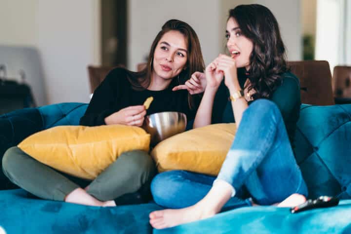 Woman watching TV together.
