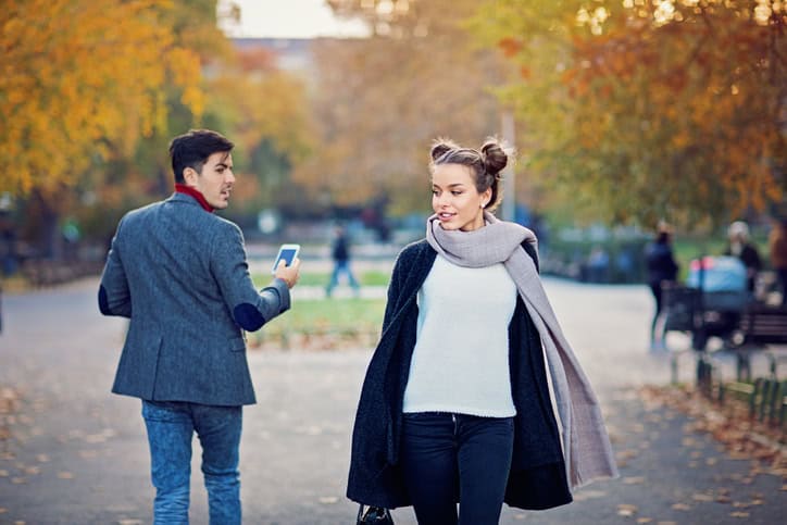 Man is walking in the city and turning around a beautiful girl
