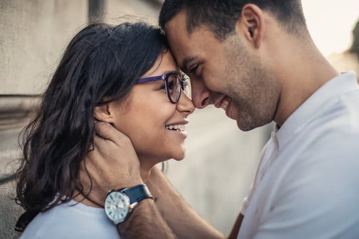 Happy young couple walking at the street
