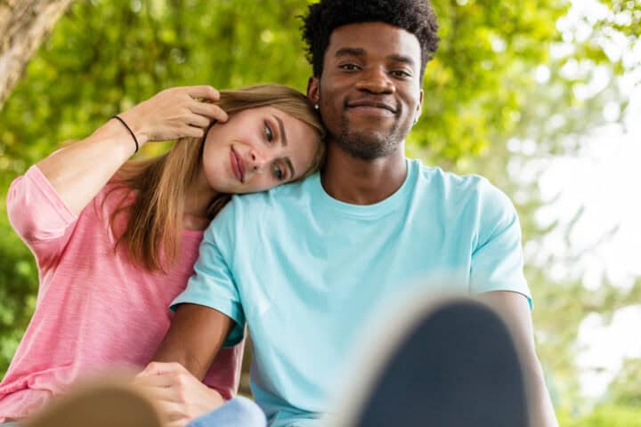 couple holding hands in park