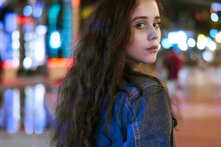 long haired woman looking over shoulder